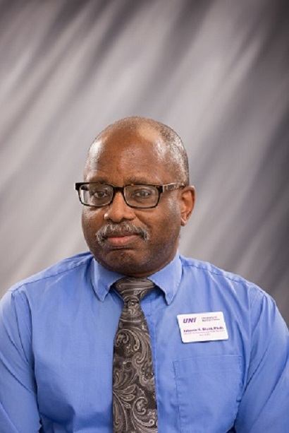 Librarian Johnnie R. Blunt in blue shirt and ornate black and grey tie